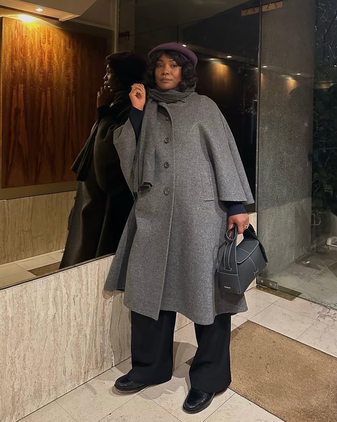 @frannfyne wearing a grey wool coat