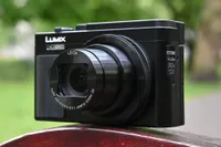 The Panasonic Lumix TZ95 perched on a wooden bench