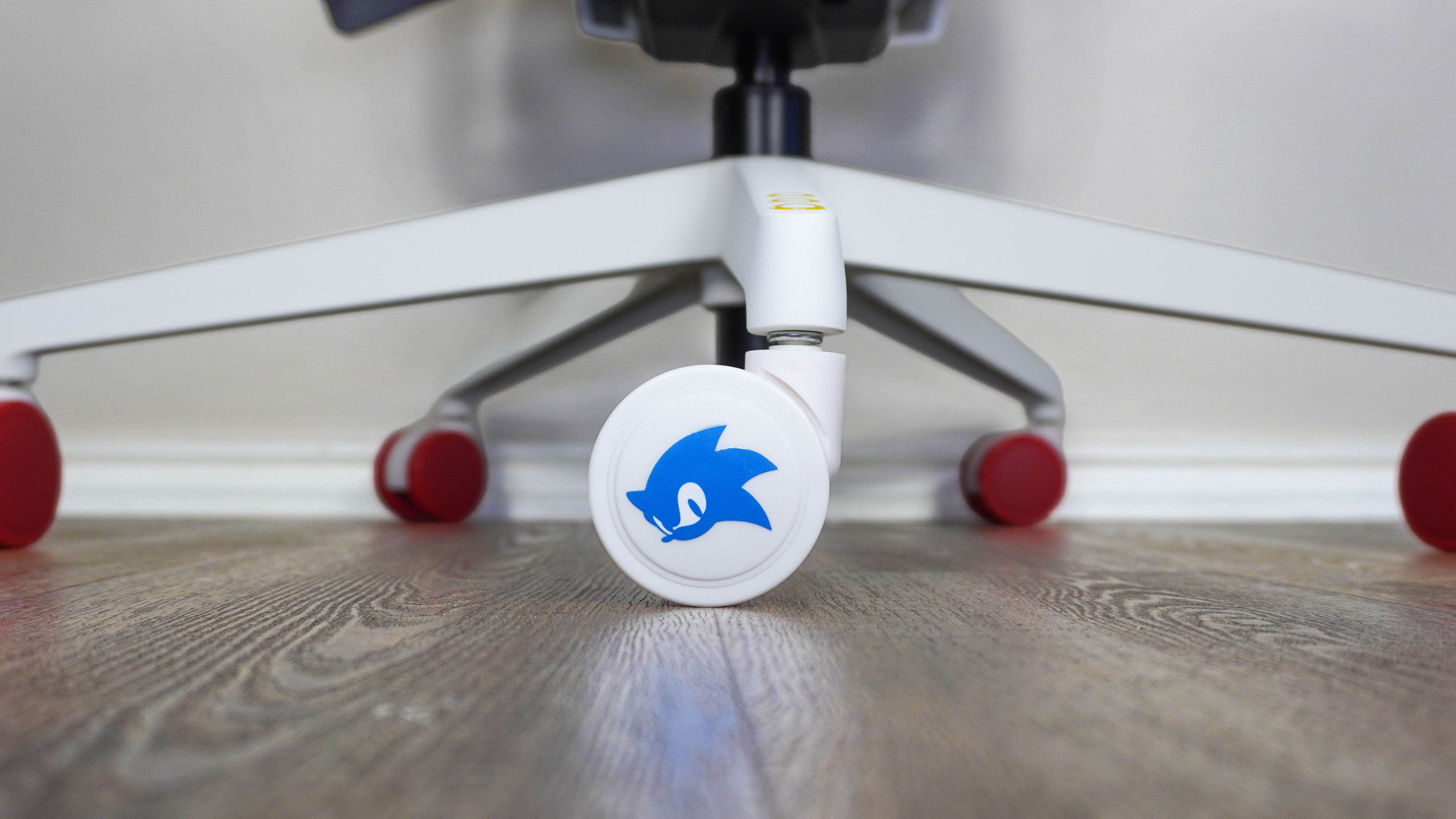 A close-up shot of the Sonic-themed accent caster on the Branch Ergonomic Chair Pro: Sonic the Hedgehog Edition