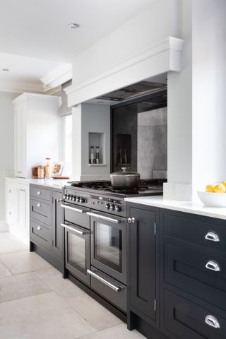 Shaker kitchen with black and white cabinetry and quartz countertops