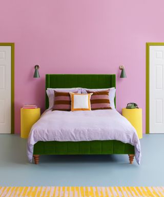 bedroom with pink walls, green headboard and lilac bedding