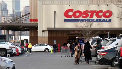 Shoppers leave a Costco store in Seattle.