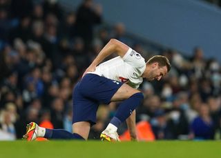 Harry Kane holds his back during the win over Manchester City