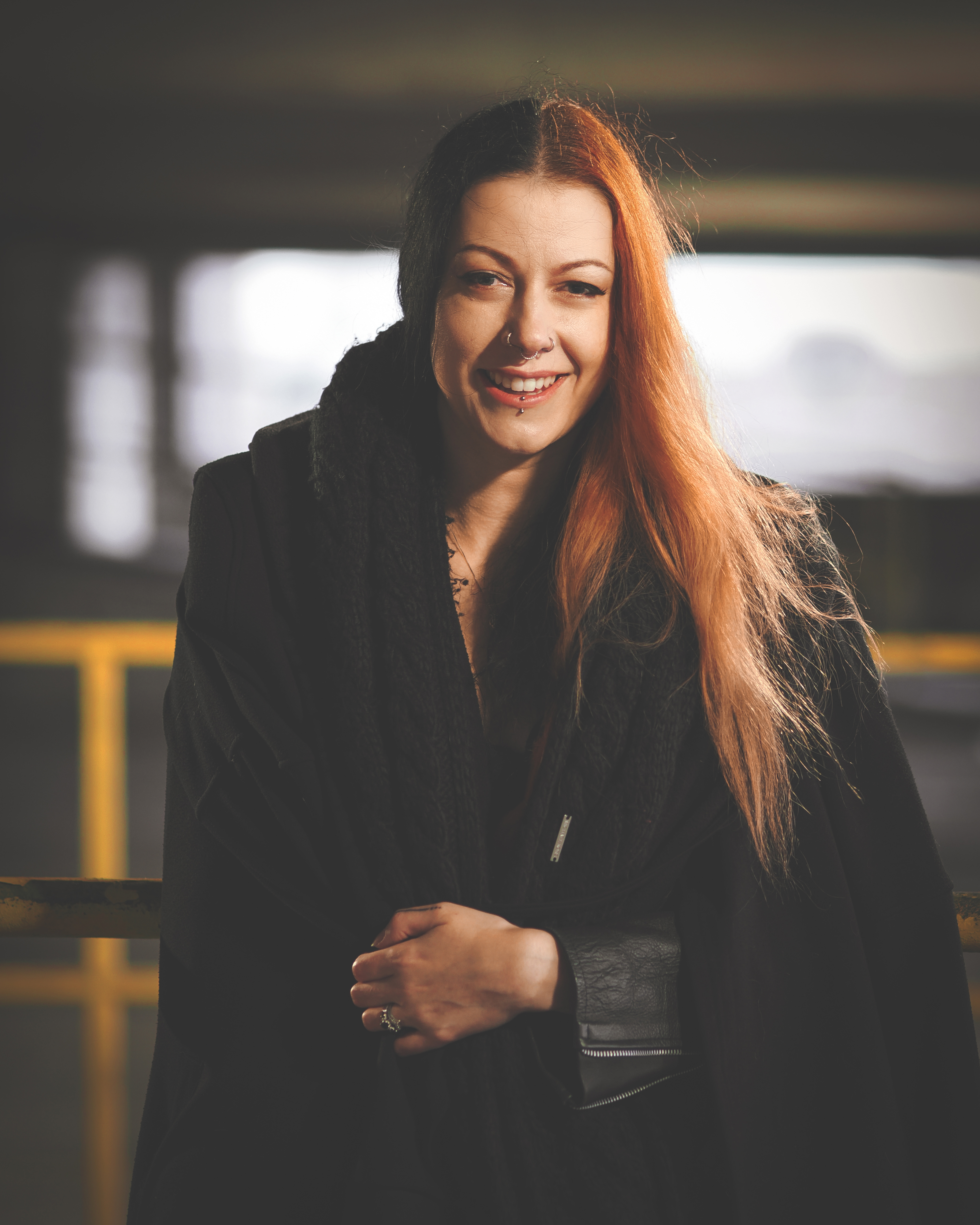 Portrait of a person in an industrial setting taken on the OM System OM-3 with the Olympus M.Zuiko 75mm f/1.8