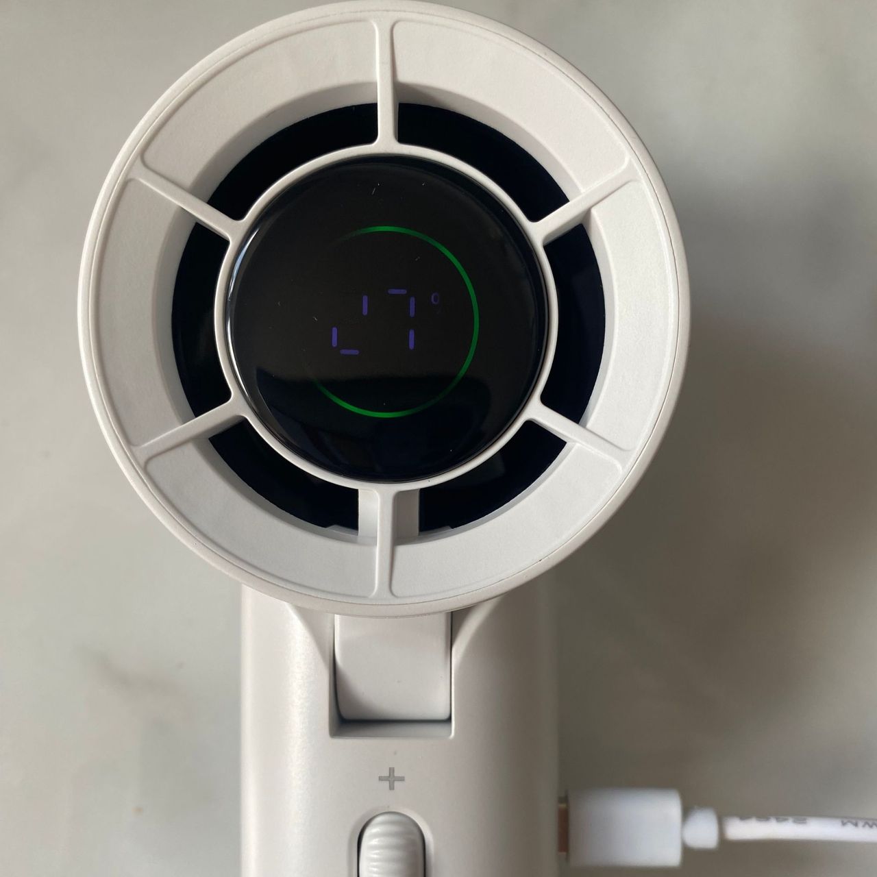 Close up of the Blueair AlwaysCool Portable Handheld Fan fan head with charging cable at the side