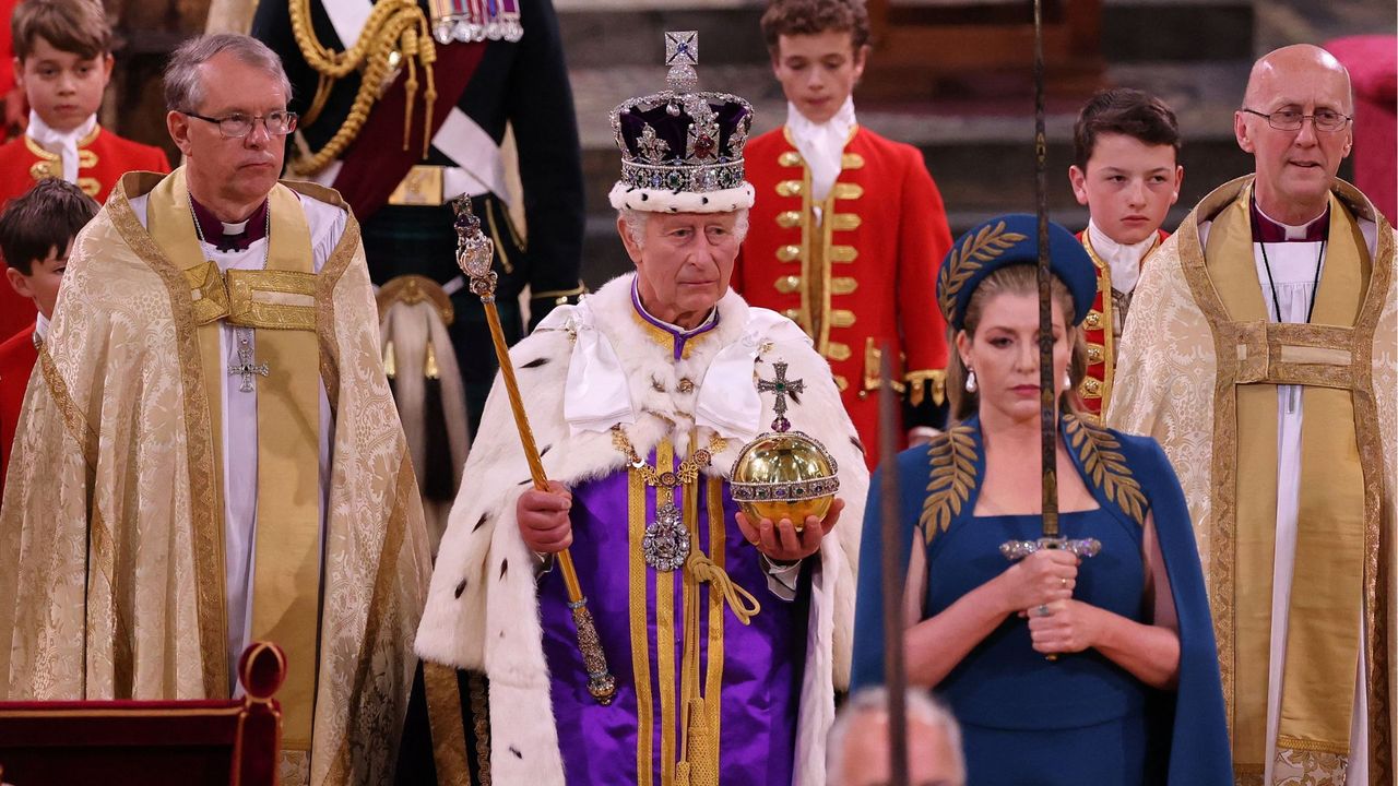 Britain&#039;s King Charles III wearing the Imperial state Crown, and carrying the Sovereign&#039;s Orb and Sceptre leaves Westminster Abbey after the Coronation Ceremonies in central London on May 6, 2023.