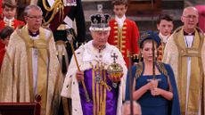 Britain's King Charles III wearing the Imperial state Crown, and carrying the Sovereign's Orb and Sceptre leaves Westminster Abbey after the Coronation Ceremonies in central London on May 6, 2023.