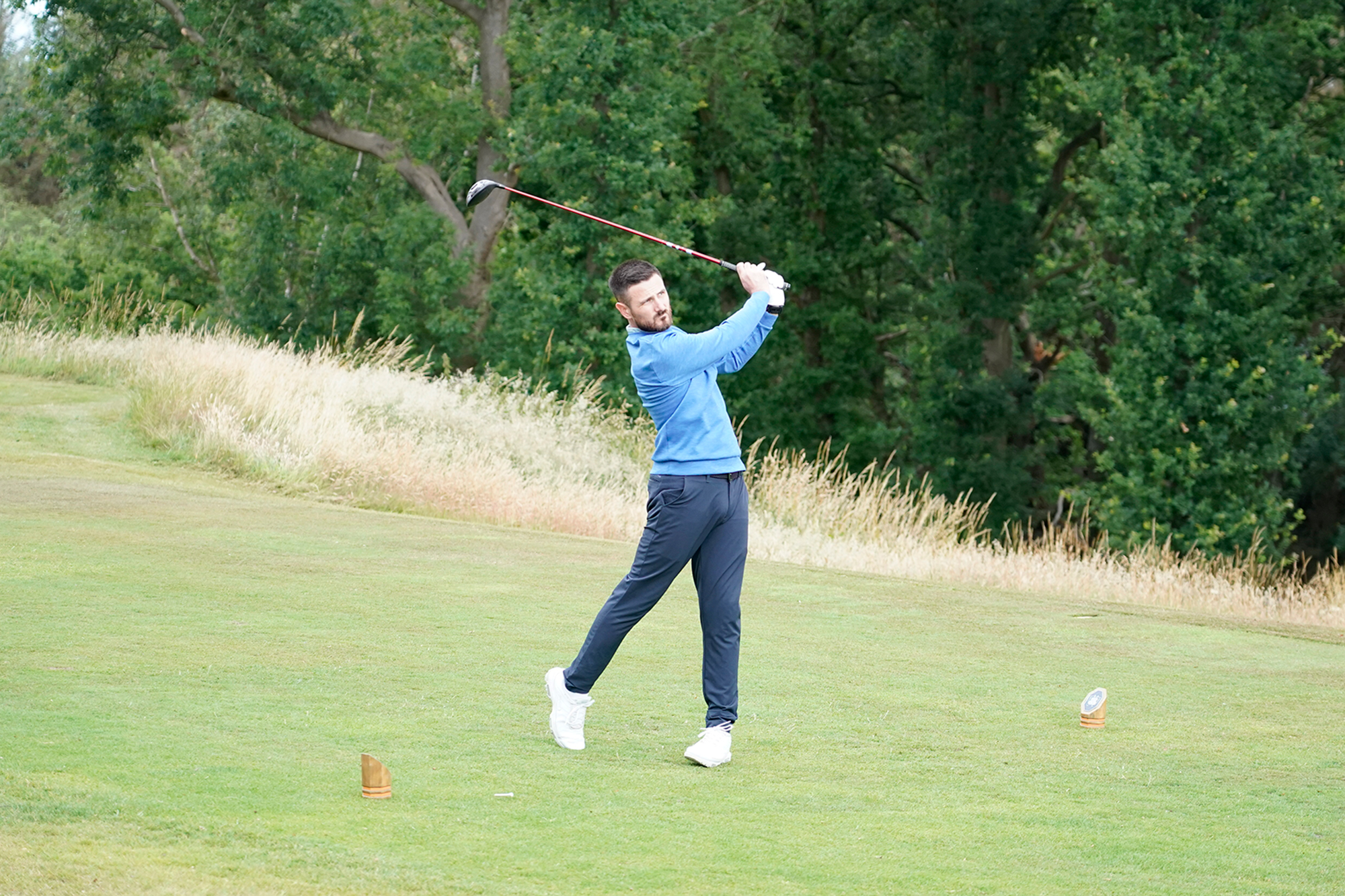 Baz Plummer hitting a driver on the 7th tee at Sand Moor Golf Club, in the finish position watching the golf ball in flight