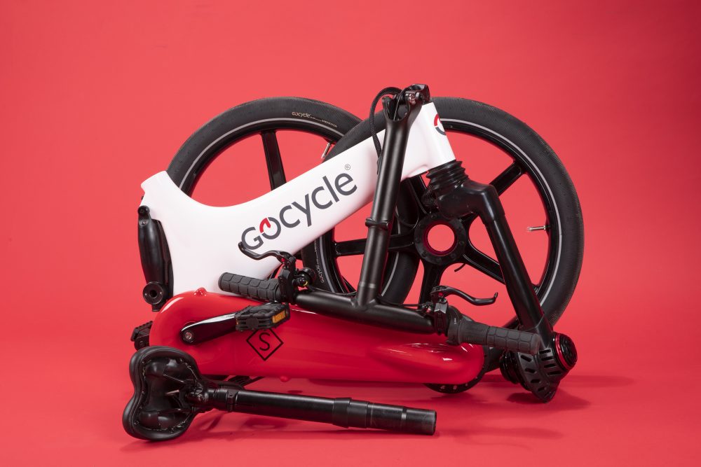 Gocycle folds into a small bundle, which can be wheeled around on an optional docking station.