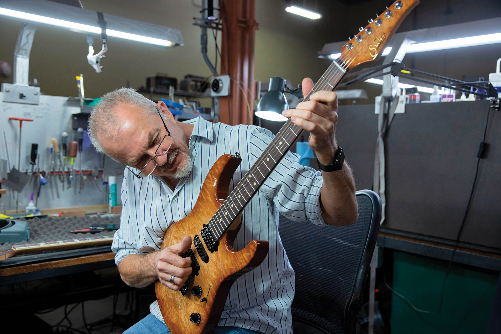 John Suhr tests one of his Modern Plus S-styles at the workplace