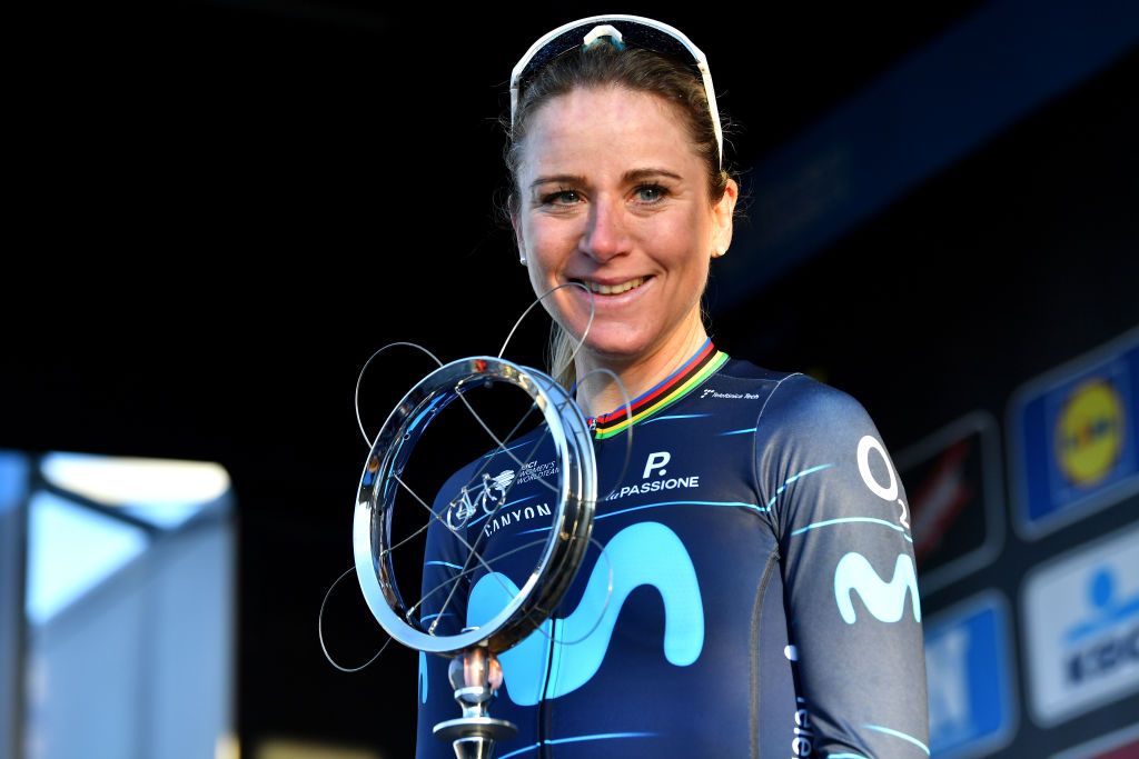 NINOVE BELGIUM FEBRUARY 26 Annemiek Van Vleuten of Netherlands and Movistar Team Women poses at podium with race trophy as winner after the 17th Omloop Het Nieuwsblad 2022 Womens Race a 128km race from Ghent to Ninove OHN22 FlandersClassic WorldTour on February 26 2022 in Ninove Belgium Photo by Luc ClaessenGetty Images