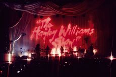 bands on stage in pink light