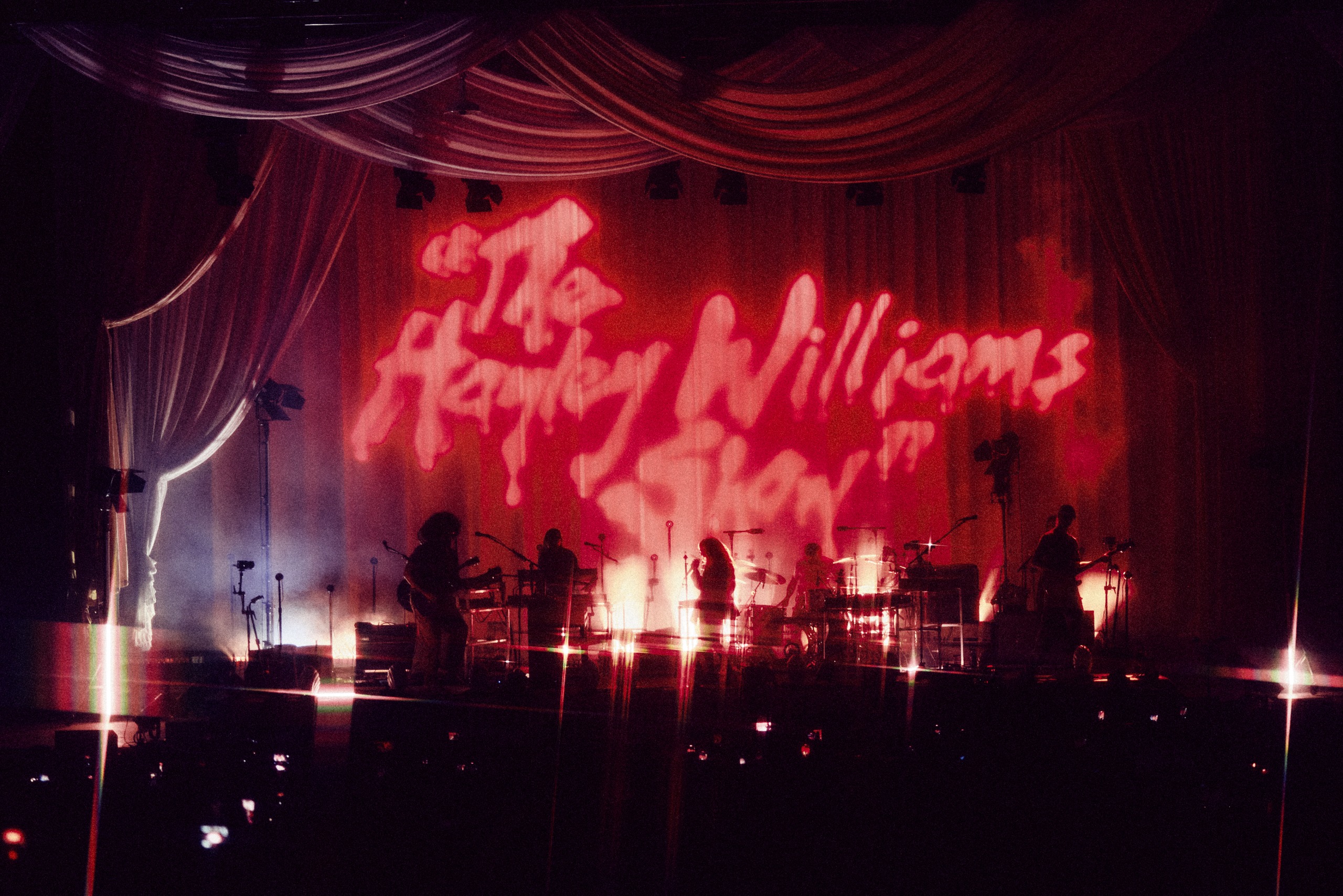 bands on stage in pink light