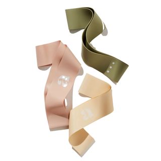 three latex reistance bands in olive green, baby pink, and beige colors