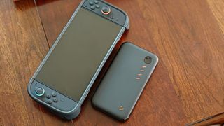 The Viture Pro Mobile Dock next to a Nintendo Switch 2 with a Dbrand Killswitch case installed