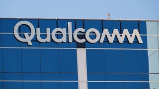A Qualcomm logo is displayed on a building on their campus