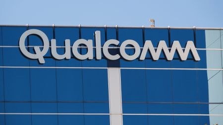A Qualcomm logo is displayed on a building on their campus