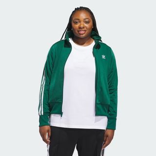 model wears green adidas track jacket and black track pants