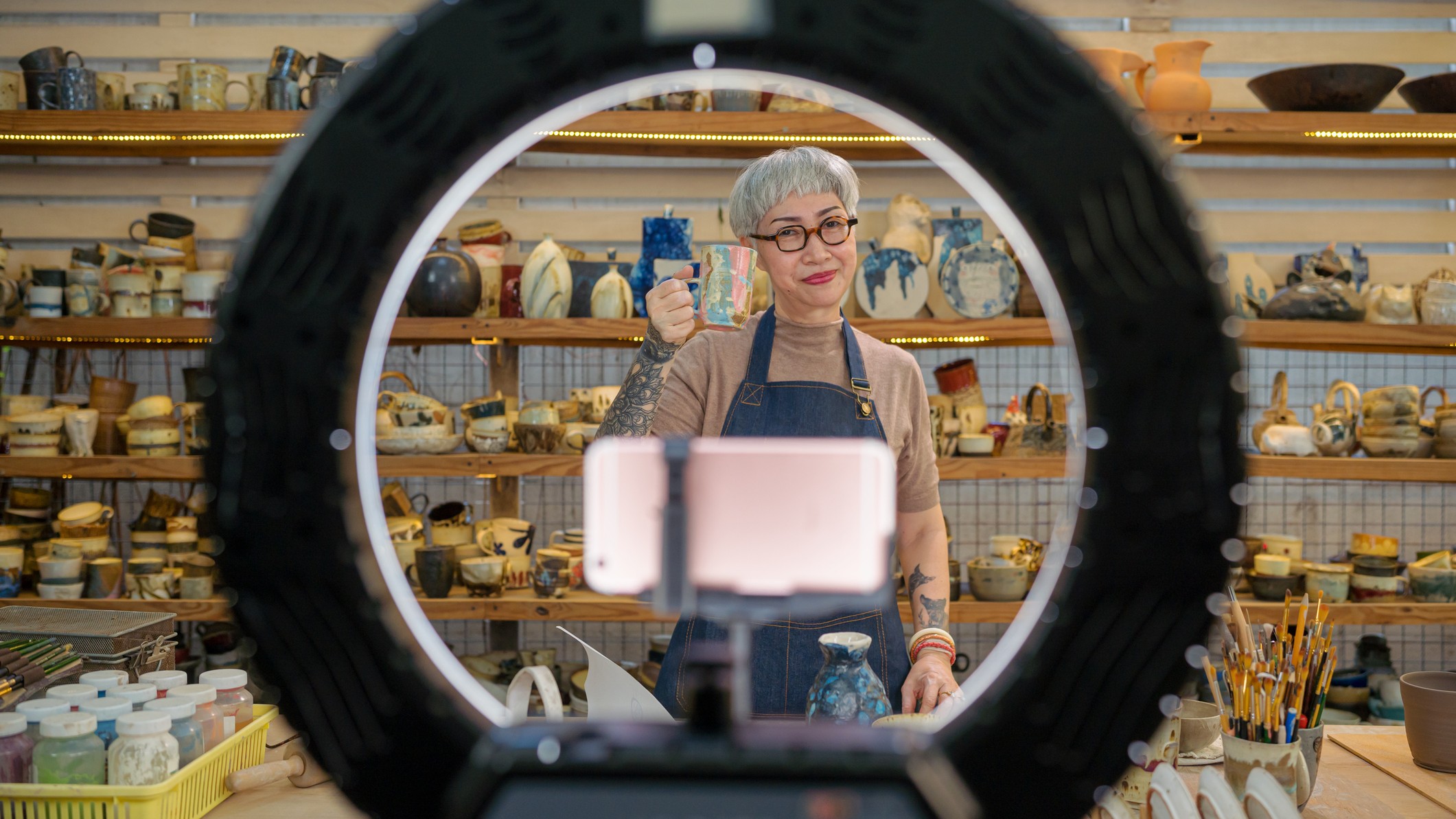 An older ceramic artist showcases her work on a video platform.