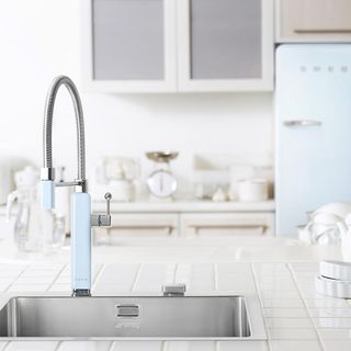 kitchen with pastel blue smeg tap and wash basin