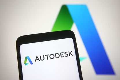 Autodesk logo on smartphone with blue and green logo in background also