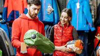 Man and woman shopping for camping gear