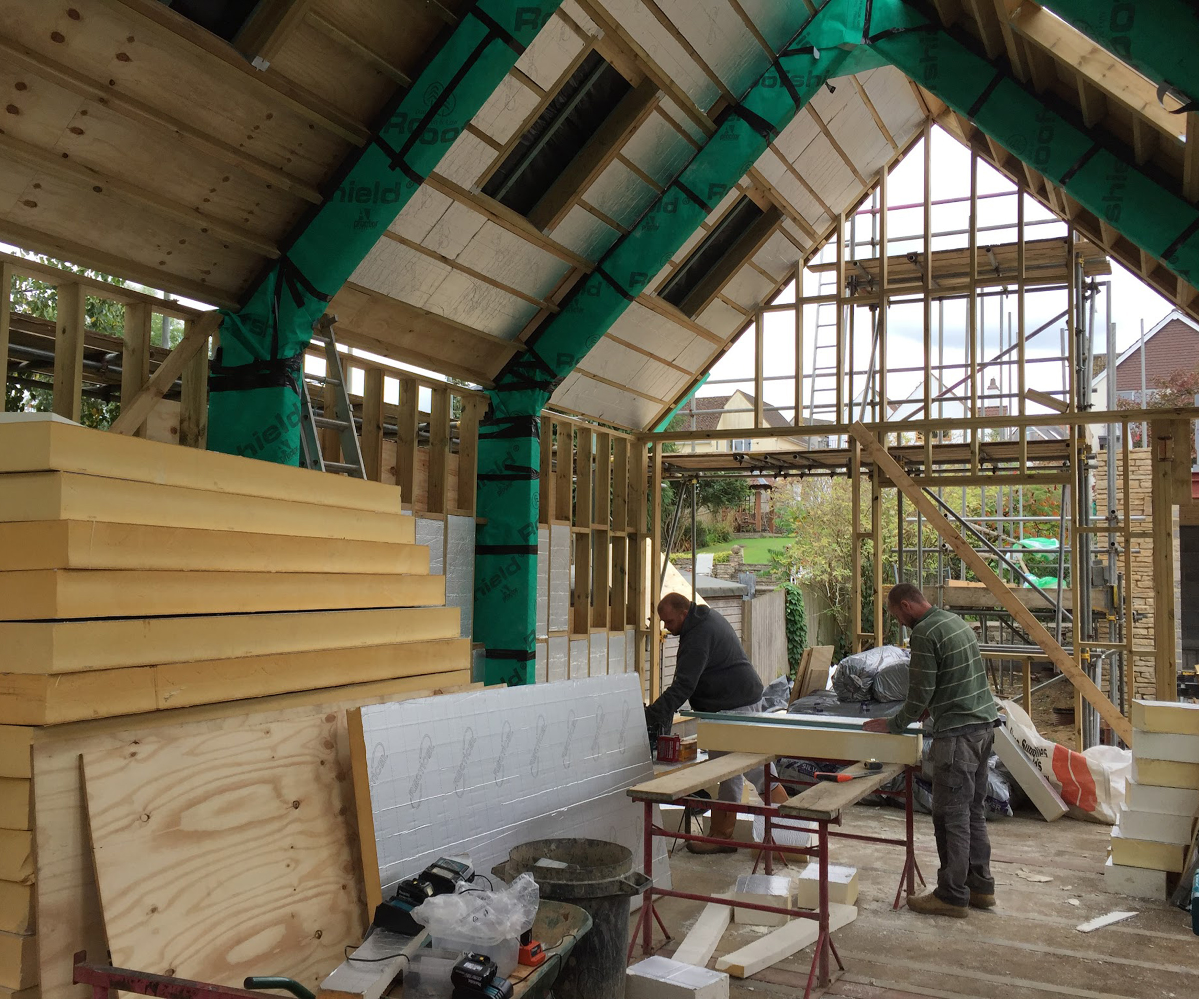 Progress shots of a self build home cutting timber planks to size