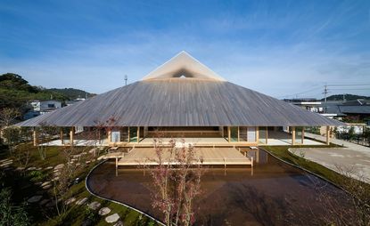 exterior view of an open plan village hall in japan with a pointed roof