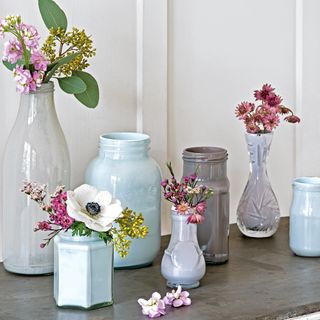 Collection of vases and jars filled with flowers
