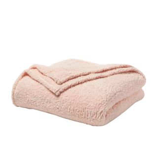 Folded pink sherpa blanket