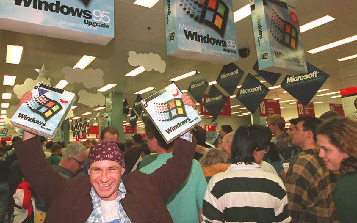 Windows 95 customer Mikol Furneaux waves two boxes in the air