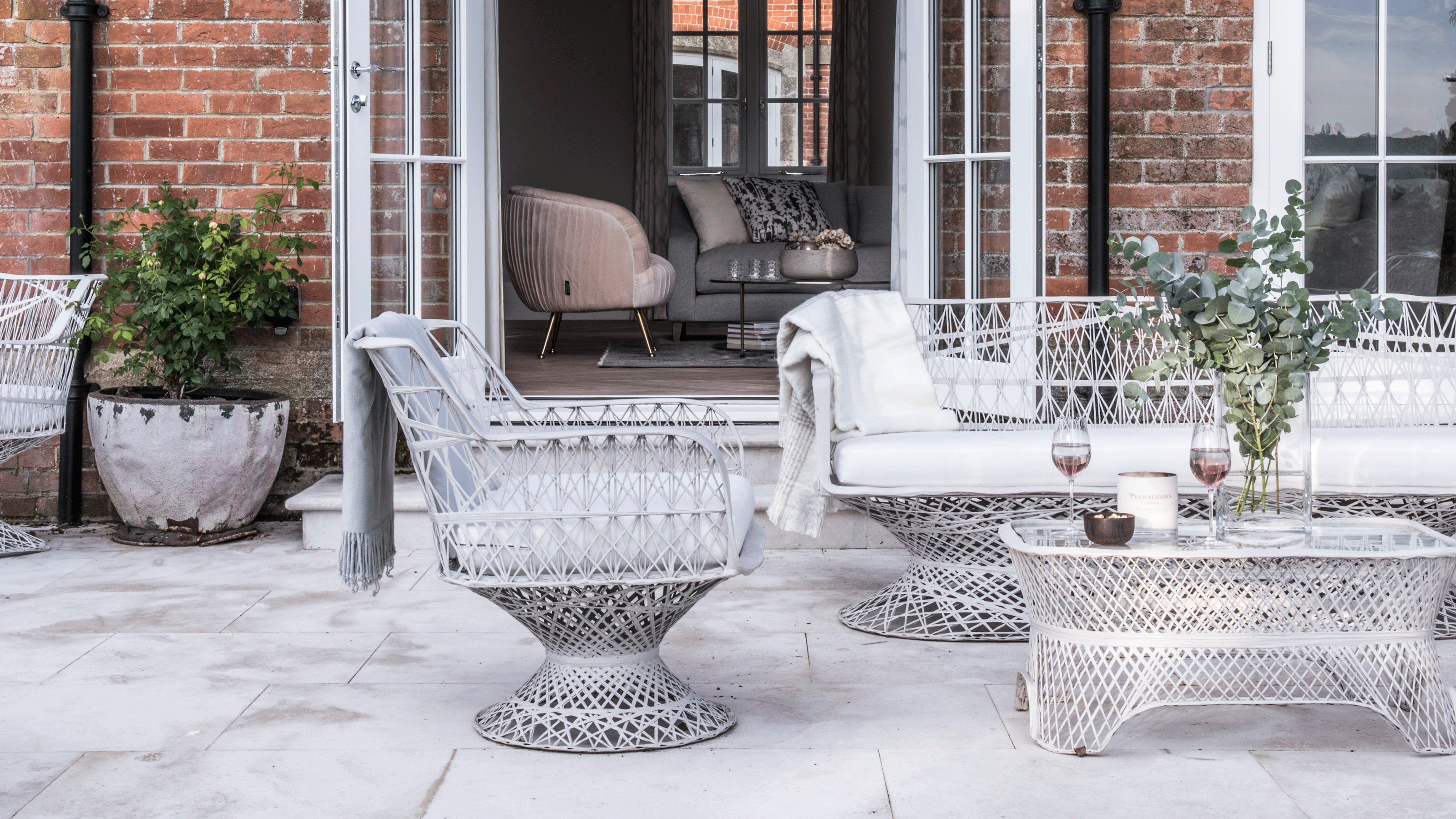 Intricate garden furniture in front of brick house