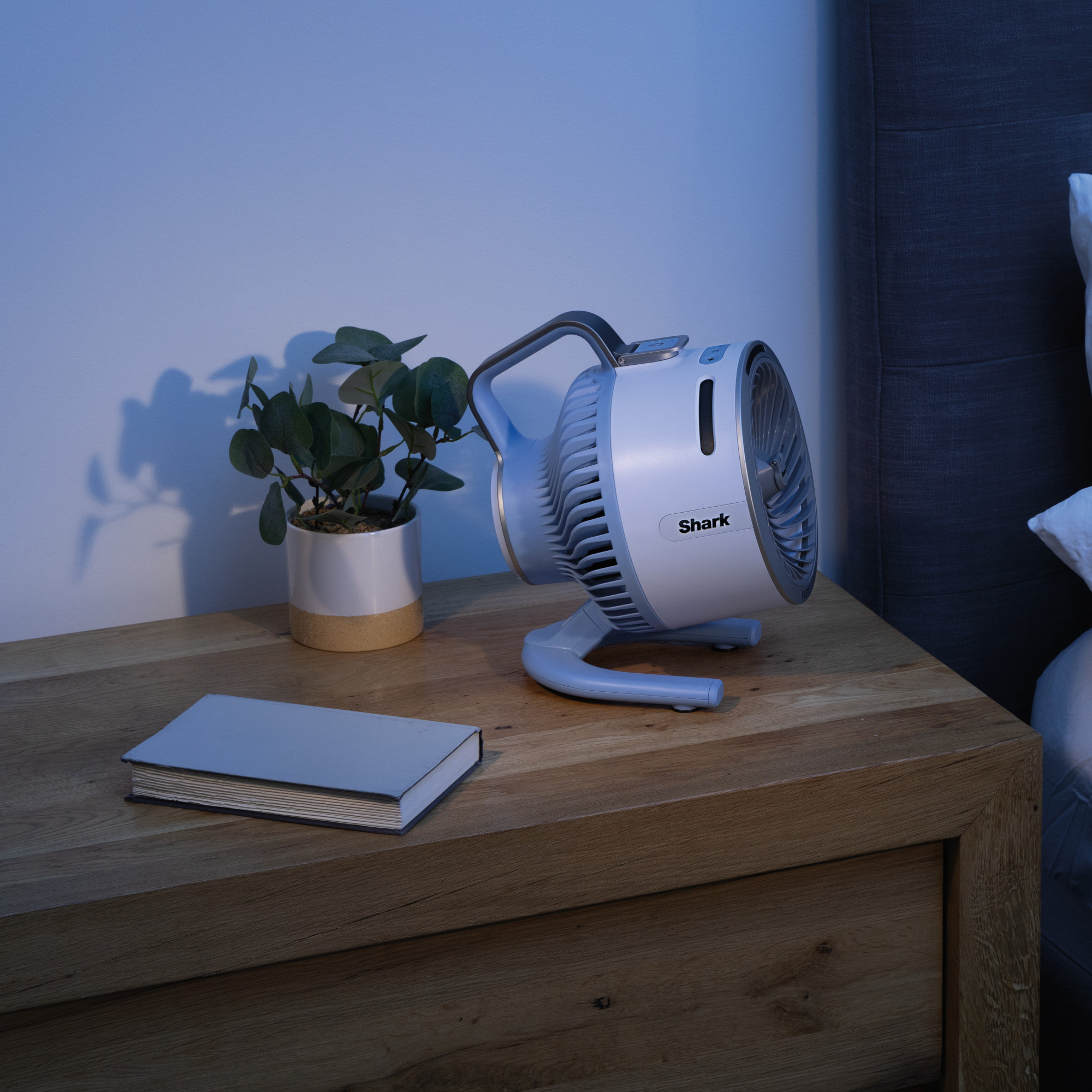 shark flexbreeze hydrogo fan on a bedside table in a bedroom