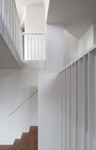 Interior with white wall and wooden stairs
