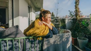 Woman with sore scalp relaxing on terrace