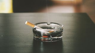 How to get rid of smoke smells in your home: Image shows cigarette in ash tray