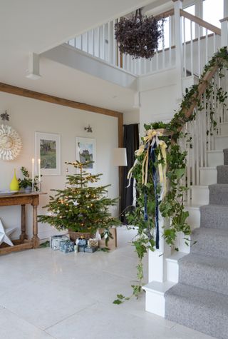 double height hallway and stair decorated for christmas