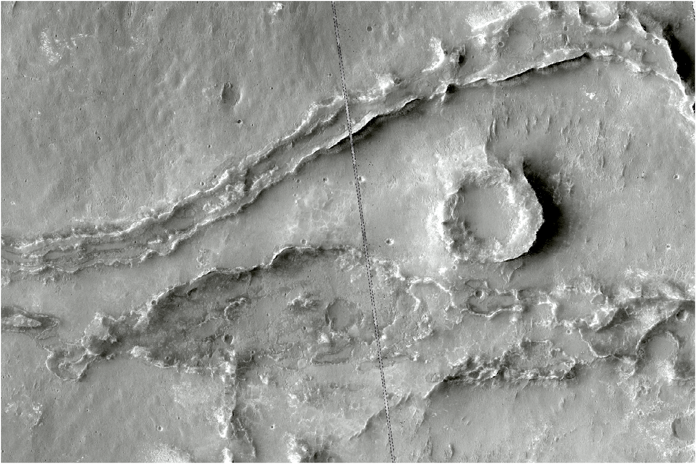 A gray-scale photo shows the surface of Mars and its corresponding ancient river beds