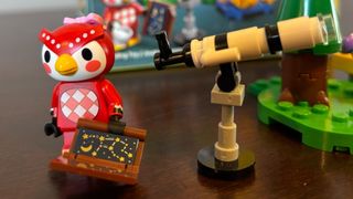 Lego Celeste minifigure beside a telescope