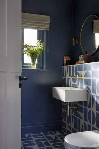 blue bathroom with geometric patterned tiles