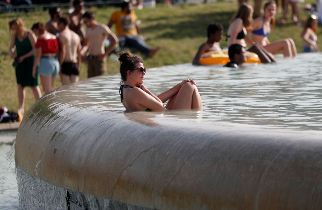 A woman sat in the Trocadero Fountain near the Eiffel Tower in Paris as temperatures in the city reached a record 113 degrees Fahrenheit (45 Celcius) on June 28.