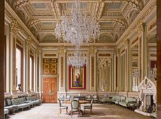 Fig 4: The drawing room is predominantly an interior of the 1860s with furniture by John G. Crace. The carpet was added in the 1920s. On the far wall is an unexpectedly alluring image of Aurora standing at the Gates of Dawn by H. J. Draper. Drapers’ Hall, London. ©Will Pryce for Country Life Magazine.