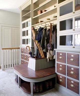 Boot room ideas by Artichoke Ltd with central umbrella console, hooks and open shelving