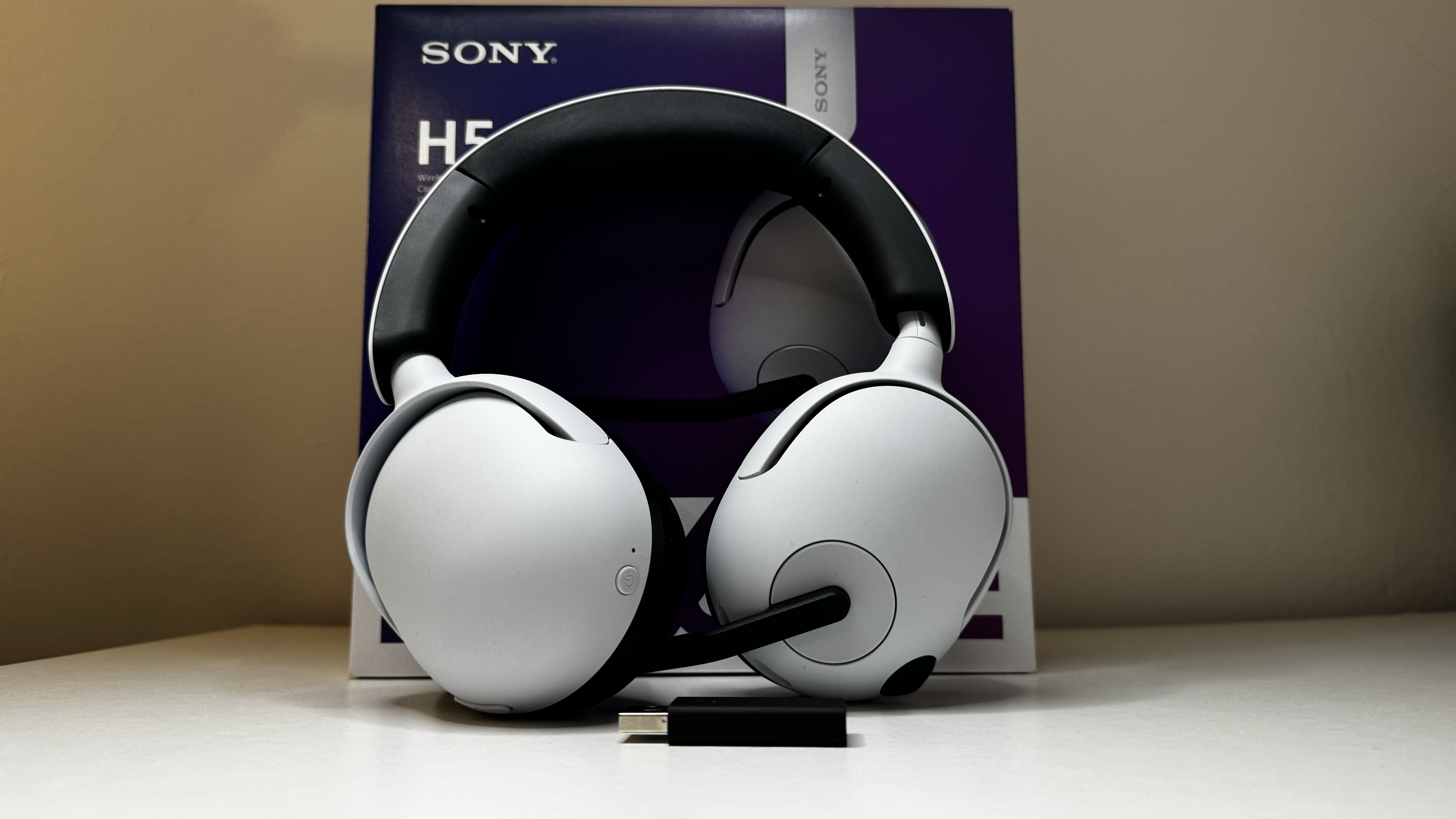 Sony InZone H5 gaming headset on a desk with packaging.