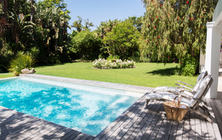 Pool with garden behind it