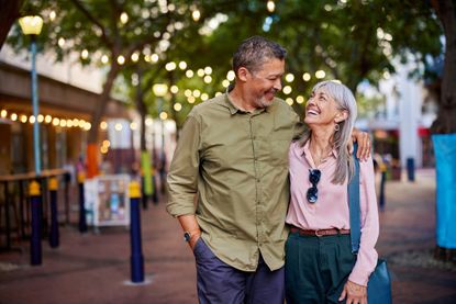 A happy, mature couple enjoys a romantic evening outdoors.