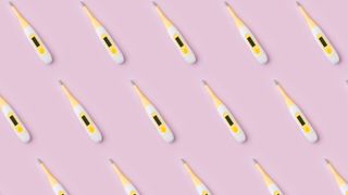Thermometers on pink background