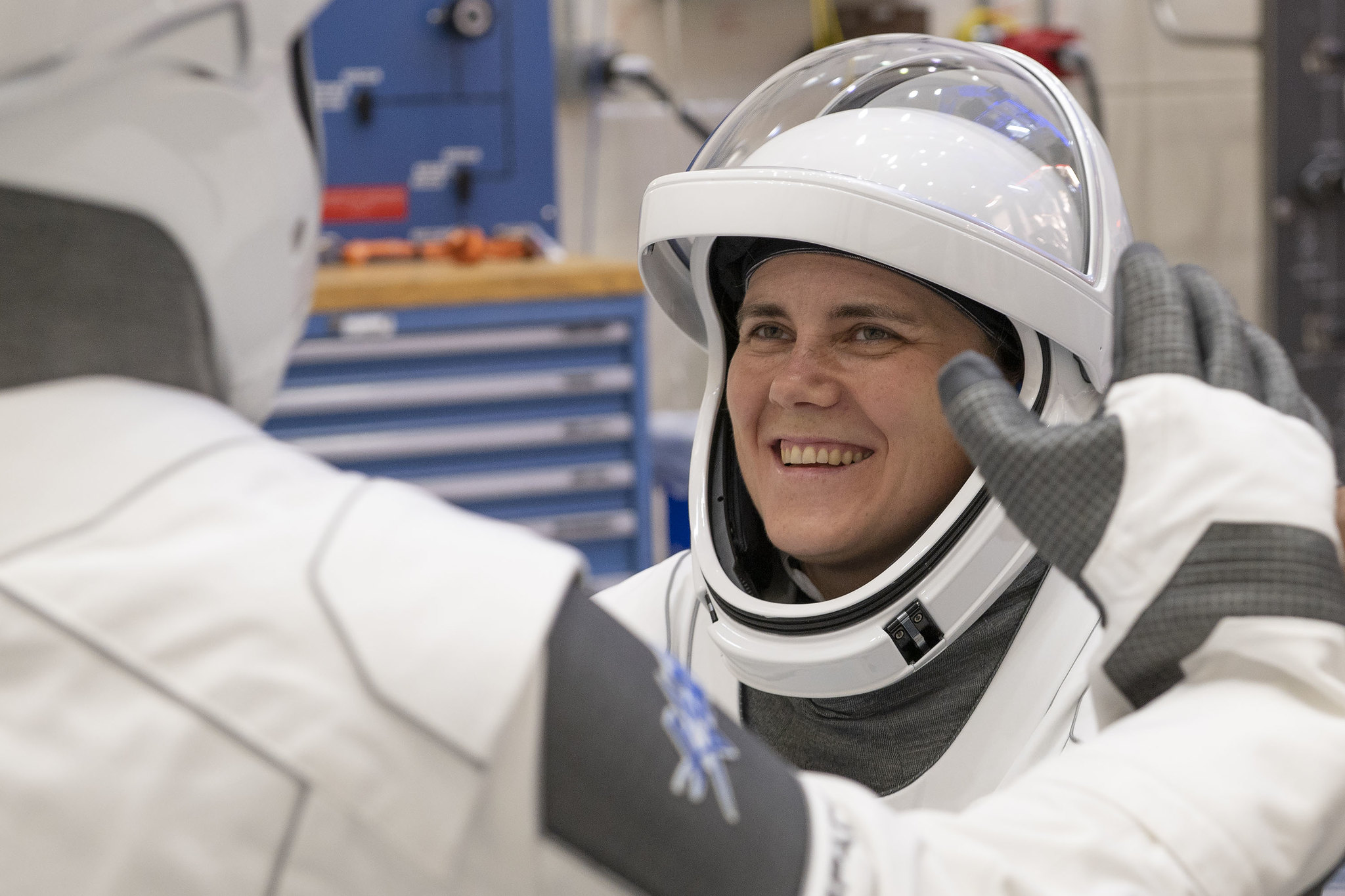 Top Stories Tamfitronics astronaut in white suit smiling, with another astronaut in white suit in front with the back showing