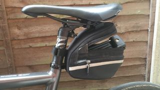 An Abus Bordo 6055k Lite folding lock fitting in a saddle bag on a hybrid bike