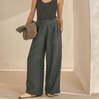 Cropped image of woman wearing wide leg green trousers